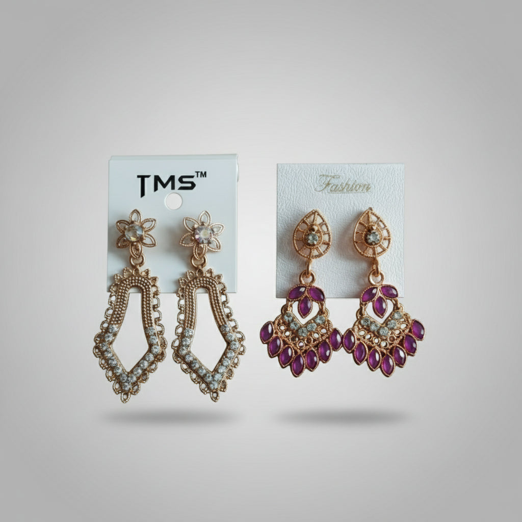 Two pairs of earrings on cards with 'TMS' branding against a light green background.