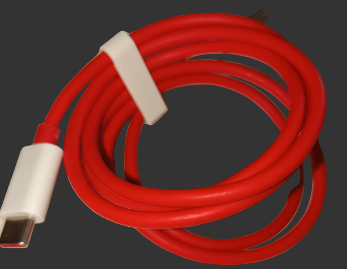 Red USB cable with white connector on a beige surface