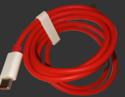 Red USB cable with white connector on a beige surface