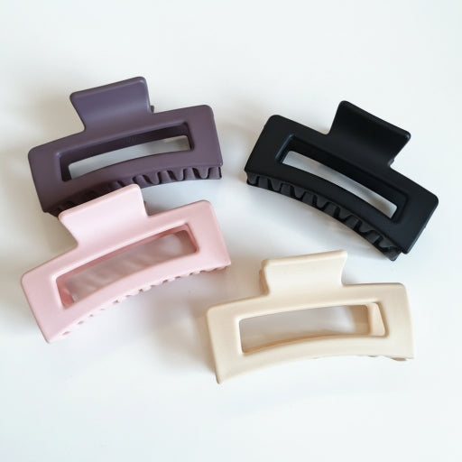 Collection of various hair clips on a textured surface